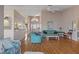 Bright living room with hardwood floors and open layout to the entry, kitchen, and dining area at 3606 Dow Ln, Spring Hill, FL 34609