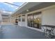 Large screened-in patio with sliding glass doors and a serene view of the surrounding landscape at 3606 Dow Ln, Spring Hill, FL 34609
