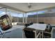 Enclosed patio featuring dining set, and a hanging swing chair, perfect for outdoor enjoyment at 3606 Dow Ln, Spring Hill, FL 34609
