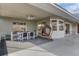Relaxing covered patio features a dining area and hanging swing chair, perfect for outdoor enjoyment at 3606 Dow Ln, Spring Hill, FL 34609