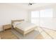 Bright bedroom featuring hardwood floors and sliding glass door to the outdoors at 5015 Us Highway 19 # 106, New Port Richey, FL 34652