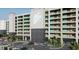Modern condo building boasts a sleek design with covered parking and lush landscaping at 5015 Us Highway 19 # 106, New Port Richey, FL 34652