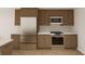 Kitchen featuring stainless steel appliances, light countertops, and wood cabinets at 5015 Us Highway 19 # 106, New Port Richey, FL 34652