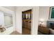 Spacious walk-in closet with custom shelving and hanging rods for organization, connecting to bathroom and bedroom at 5015 Us Highway 19 # 308, New Port Richey, FL 34652