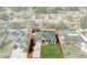 Aerial view of the property with a well-manicured lawn, above-ground pool, and fenced backyard at 5139 Jenson Ave, Spring Hill, FL 34608