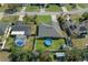 Aerial view of a home with a well-maintained yard and a round above-ground pool, all enclosed by a white privacy fence at 5139 Jenson Ave, Spring Hill, FL 34608