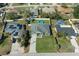 Aerial view of a home in a residential neighborhood, featuring a manicured lawn and above-ground swimming pool at 5139 Jenson Ave, Spring Hill, FL 34608