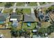 Overhead image of a home featuring an above-ground pool, lush green yard, shed, and white privacy fence at 5139 Jenson Ave, Spring Hill, FL 34608