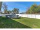 Spacious backyard featuring a well-maintained lawn, white fence, above-ground pool, and storage shed at 5139 Jenson Ave, Spring Hill, FL 34608