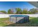 Backyard pool with a well-kept yard, surrounded by a white fence, offering privacy and relaxation at 5139 Jenson Ave, Spring Hill, FL 34608