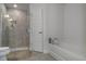Bathroom with a tiled shower, separate bathtub, and modern fixtures at 5139 Jenson Ave, Spring Hill, FL 34608