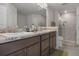 Bathroom featuring dual vanities, granite countertops, and a glass-enclosed shower at 5139 Jenson Ave, Spring Hill, FL 34608