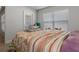 Comfortable bedroom featuring a floral patterned bedspread, natural light, and cozy decor at 5139 Jenson Ave, Spring Hill, FL 34608
