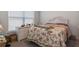 Bright bedroom with a floral patterned bedspread, natural light, and a dresser at 5139 Jenson Ave, Spring Hill, FL 34608