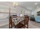 Bright dining area with a table, chair set, large window, and entry to the living room at 5139 Jenson Ave, Spring Hill, FL 34608