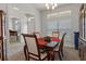 Formal dining room with a dark wood table, upholstered chairs, and a view into the entryway at 5139 Jenson Ave, Spring Hill, FL 34608