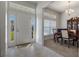Welcoming foyer with tiled floors, a front door with sidelights, and a view of the formal dining area at 5139 Jenson Ave, Spring Hill, FL 34608