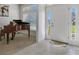 Inviting foyer with ceramic tile, grand piano, and view into the dining room with natural light at 5139 Jenson Ave, Spring Hill, FL 34608