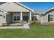 Inviting home entrance with stone pillars and a meticulously landscaped front yard at 5139 Jenson Ave, Spring Hill, FL 34608