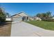 Well-maintained single Gathering home features an extended driveway and lush green lawn at 5139 Jenson Ave, Spring Hill, FL 34608