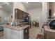 Modern kitchen with stainless steel appliances, granite counters, and views into the dining area at 5139 Jenson Ave, Spring Hill, FL 34608