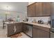Modern kitchen with stainless appliances, stone counters, and adjacent dining area at 5139 Jenson Ave, Spring Hill, FL 34608