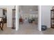 Open concept living room features tile entryway, neutral carpet, and open doorway at 5139 Jenson Ave, Spring Hill, FL 34608