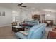 Spacious living room with carpet flooring and open floorplan to the dining and kitchen area at 5139 Jenson Ave, Spring Hill, FL 34608