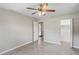 This bedroom features tile floors, a ceiling fan and an open door leading to another room at 5345 Carlton Rd, New Port Richey, FL 34652