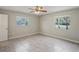 Bedroom with tile flooring, neutral walls, and natural light from two windows at 5345 Carlton Rd, New Port Richey, FL 34652