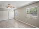 Bedroom features tile flooring, two closets, and a window, providing a comfortable and functional space at 5345 Carlton Rd, New Port Richey, FL 34652