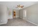 Spacious bonus room with tile flooring, ceiling fan, and neutral paint, open to the kitchen at 5345 Carlton Rd, New Port Richey, FL 34652