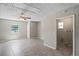 The bonus room offers flexible space with a ceiling fan, tile flooring, and access to a laundry room at 5345 Carlton Rd, New Port Richey, FL 34652