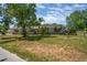 Charming single-story home featuring mature trees and a well-manicured lawn in a quiet neighborhood at 5345 Carlton Rd, New Port Richey, FL 34652