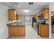 Well-appointed kitchen featuring wooden cabinets, granite countertops, stainless steel appliances, and tile flooring at 5345 Carlton Rd, New Port Richey, FL 34652