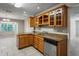 Kitchen with granite countertops, stainless steel appliances, wood cabinets, and a view into the adjacent dining area at 5345 Carlton Rd, New Port Richey, FL 34652