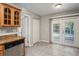 Bright kitchen featuring wood cabinets, granite countertops, stainless steel appliances, and outdoor access at 5345 Carlton Rd, New Port Richey, FL 34652