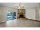 Spacious living room features tile flooring, stone fireplace, sliding glass doors to a screened patio at 5345 Carlton Rd, New Port Richey, FL 34652