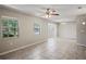 Bright and airy living room featuring tile flooring, large windows, neutral walls, and modern lighting at 5345 Carlton Rd, New Port Richey, FL 34652