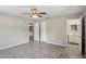 Main bedroom with tile floors, ceiling fan, and en-suite bathroom at 5345 Carlton Rd, New Port Richey, FL 34652