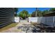 Long driveway leading to a secure, gated backyard area at 5748 Massachusetts Ave, New Port Richey, FL 34652