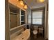 Neutral bathroom with a combined tub and shower, vanity, and plenty of mirrored cabinet storage at 6228 Lonnie Lee Ln, Hudson, FL 34667