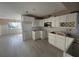 Modern kitchen with white cabinets, stainless steel microwave, and tile floors with great natural light at 6228 Lonnie Lee Ln, Hudson, FL 34667