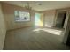 Bright living room featuring tile floors, natural light from window, and a charming chandelier at 6228 Lonnie Lee Ln, Hudson, FL 34667