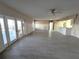 Bright living room with tile floors, double doors to lanai, and an open layout at 6228 Lonnie Lee Ln, Hudson, FL 34667