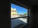 View from window shows a neighboring yellow house and palm tree at 6228 Lonnie Lee Ln, Hudson, FL 34667
