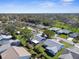 Aerial view of a residential community, surrounded by lush greenery, showcasing neighborhood's layout and landscape at 6387 Plantation Rd, Spring Hill, FL 34606