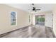 Bedroom with vinyl plank floors, a ceiling fan, neutral paint, and sliding glass doors to the lanai at 6387 Plantation Rd, Spring Hill, FL 34606