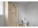 Small bathroom features a standup shower with tile and a toilet in a minimal space at 6414 Kelso Dr, Port Richey, FL 34668