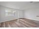 Bright living room featuring fresh white walls, modern flooring, and ample natural light at 6414 Kelso Dr, Port Richey, FL 34668